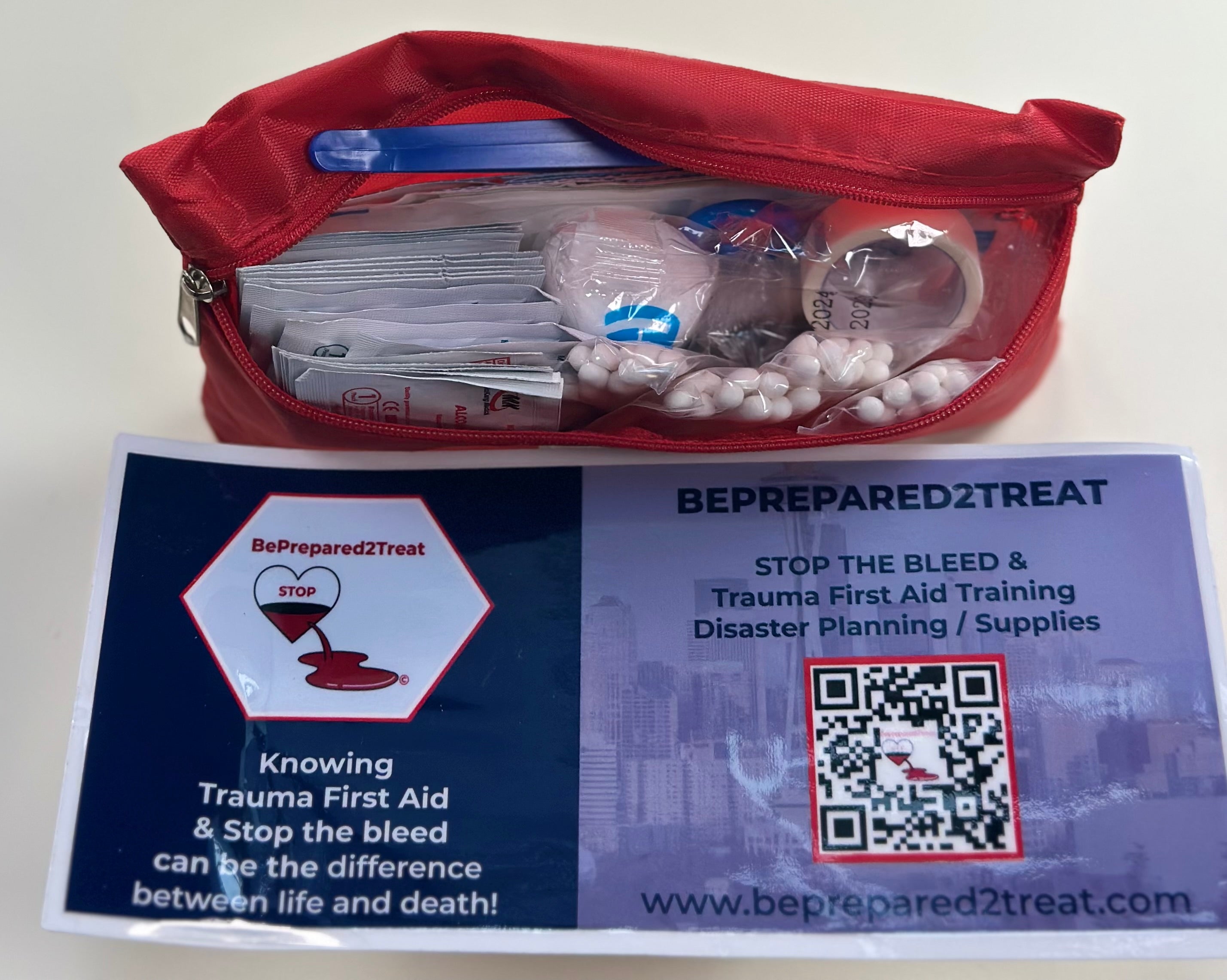 Black BePrepared2Treat IFAK opened to show the red interior trauma-supply insert.