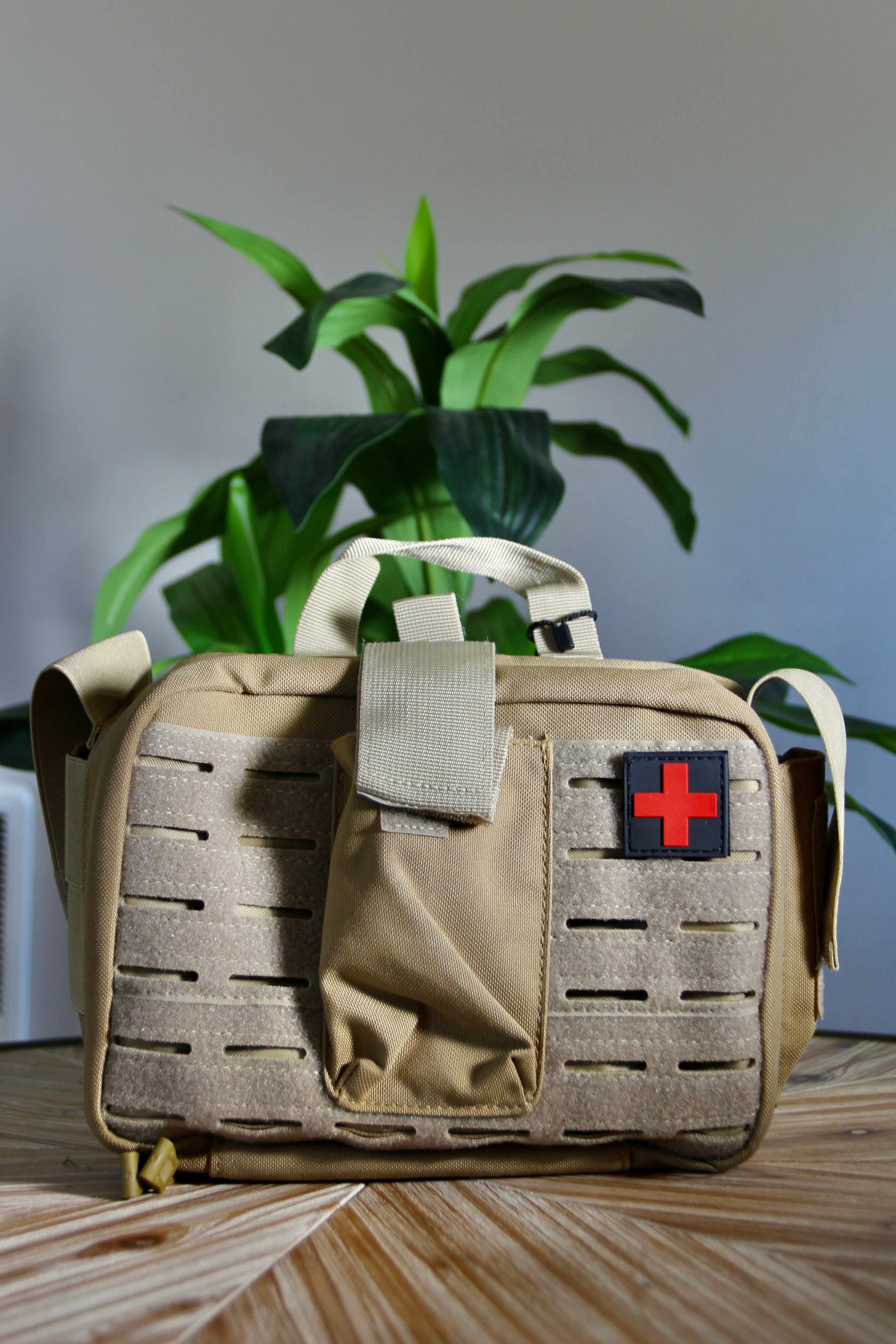 Tan Police2Bag Bag Only with MOLLE webbing, carry handle, attachment straps, and medical cross patch.