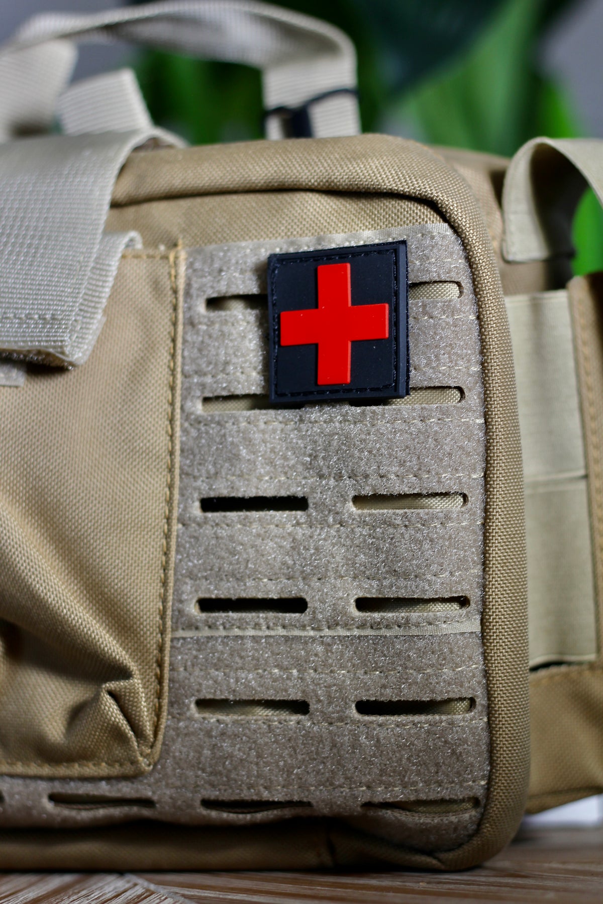 Close-up of tan Police2Bag Bag Only showing MOLLE attachment webbing and red medical cross patch.
